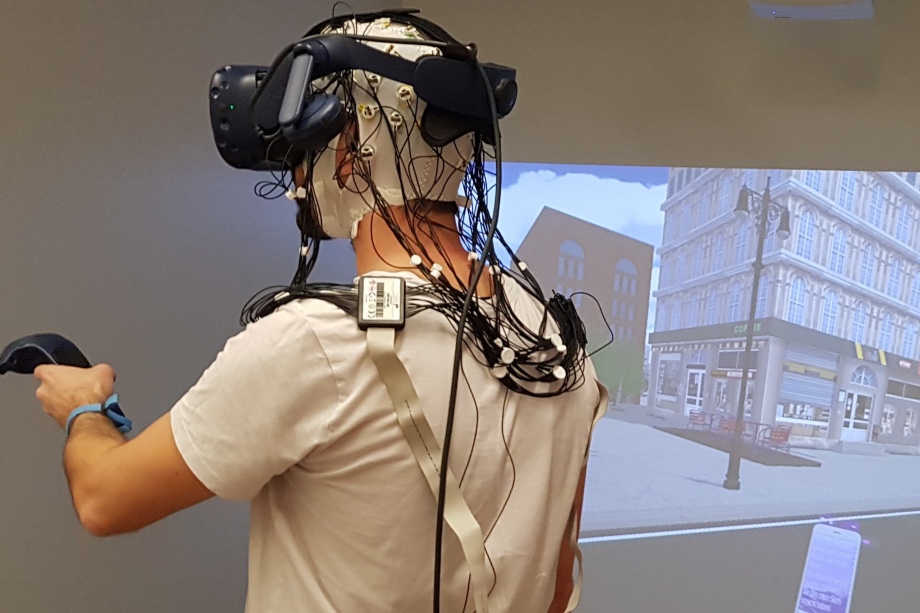 A participant wearing the mobile EEG system in our cave automated virtual environment