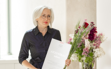 Conductor Evita Taranda with her commendation and flowers