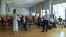 View of conference participants listening to two speakers