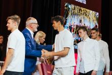 Row of athletes waiting to shake the hand of the university rector at the ceremony