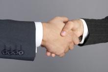 Two men's hands clasped in a handshake